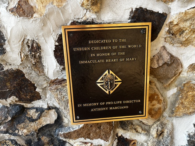 Bronze plaque at the grotto dedicated to the unborn children of the world in honor of the Immaculate Heart of Mary, placed by the Knights of Columbus in memory of pro-life director Anthony Marciano